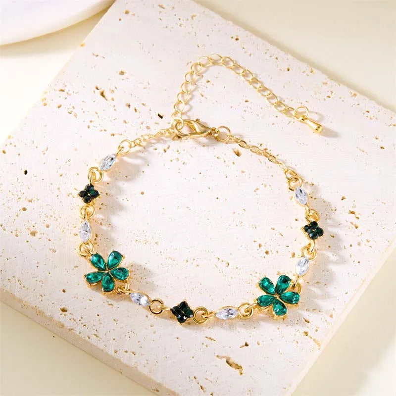 Bracelet doré avec cristaux et fleurs vertes