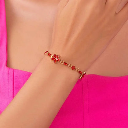 Bracelet doré avec cristaux et fleurs rouges