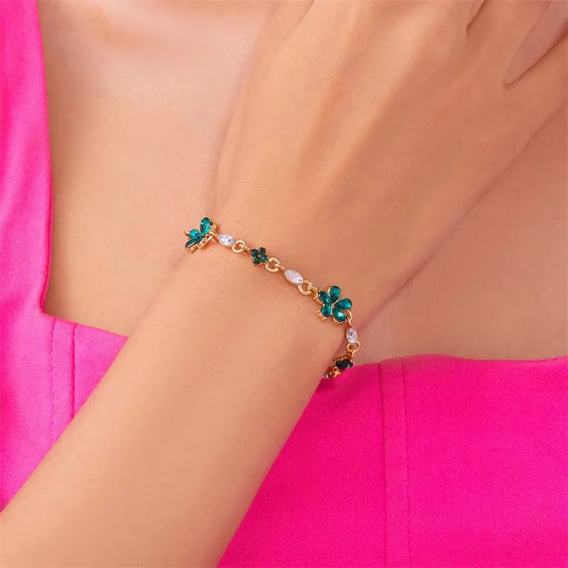 Bracelet doré avec cristaux et fleurs vertes