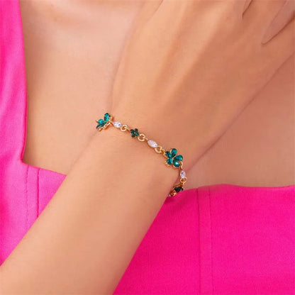 Bracelet doré avec cristaux et fleurs vertes
